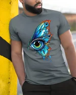 Surreal Butterfly Eye Dripping Tshirt - model leaning on yellow-black pole, wearing Gray T-shirt, hand in pocket