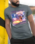 One Nation Under God T-shirt - model leaning on yellow-black pole, wearing Gray T-shirt, hand in pocket