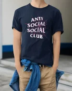 Anti Social Spider Web Tee - model wearing Navy T-shirt, hands in pockets, denim shirt at waist