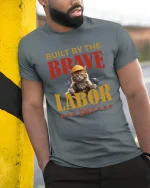Built By The Brave Labor Day Cat T-Shirt - model leaning on yellow-black pole, wearing Gray T-shirt, hand in pocket