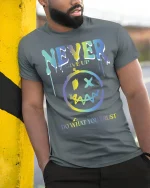 Never Give Up Motivational Graphic Tee - model leaning on yellow-black pole, wearing Gray T-shirt, hand in pocket