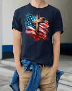 Patriotic American Flag Cross Tee - model wearing Navy T-shirt, hands in pockets, denim shirt at waist