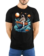 Astronaut in Boat Exploring Space T-Shirt - model with hands behind back, wearing Black T-shirt and blue jeans