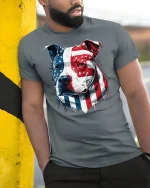 American Flag Pitbull Patriotic Dog T-Shirt - model leaning on yellow-black pole, wearing Gray T-shirt, hand in pocket