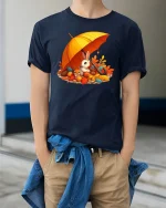 Cozy Autumn Bunny Tee - Cute Fall Squirrel Friends Shirt - model wearing navy tee with hands in pockets