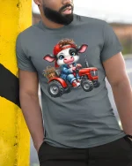 Cute Farmer Cow Riding Red Tractor Funny Graphic Tee - model wearing grey tee, leaning on column
