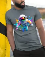 Color Splash Astronaut Space Art Cool Graphic Tee - model wearing grey tee, leaning on column