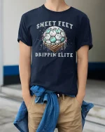 Sweet Feet Drippin’ Elite T-Shirt Funny Soccer Style - model wearing navy tee with hands in pockets