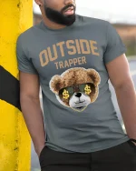 Outside Trapper T-Shirt - model leaning on yellow-black pole, wearing Gray T-shirt, hand in pocket
