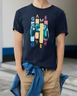 Retro Game Over Controller Tee for Gamers and Console Lovers - model wearing navy tee with hands in pockets