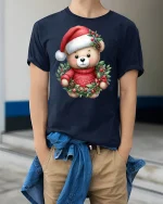 Cute Christmas Teddy Bear Tee in Wreath Red Holiday Graphic Tshirt - model in navy tee with hands in pockets
