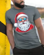 Cool Santa Wearing Sunglasses Graphic Tee With Fun Holiday Style - model wearing grey tee, leaning on column