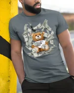 Funny Rich Teddy Bear Money Graphic Tee With Bold Street Humor - model wearing grey tee, leaning on column