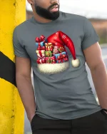 Christmas Santa Hat Gift Stack Tee With Festive Holiday Cheer - model wearing grey tee, leaning on column