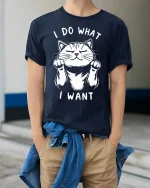 Funny Cat Attitude Graphic Tee With Cute I Do What I Want Design - model wearing navy tee with hands in pockets