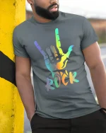 Rainbow Rock Hand Sign Graphic Tee Colorful Music Style Shirt - model wearing grey tee, leaning on column