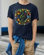 Christmas Music Wreath Tee with Treble Clef Holiday Lights - model wearing navy tee with hands in pockets