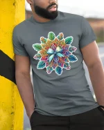 Colorful Mandala Art Tee with Intricate Floral Pattern - model wearing grey tee, leaning on column