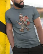Funny Viking Warrior Tee with Cartoon Shield and Spear Art - model wearing grey tee, leaning on column