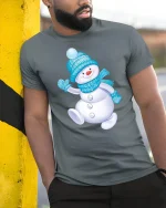 Cute Snowman Winter Tee with Cozy Blue Hat and Scarf Artwork - model wearing grey tee, leaning on column