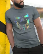 Holographic Dripping Skull Neon Glow Savage Graphic Art Tee - model wearing grey tee, leaning on column