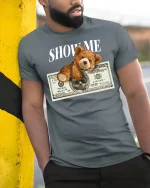 Show Me Money Teddy Bear Funny Cash Style Graphic Tee - model wearing grey tee, leaning on column