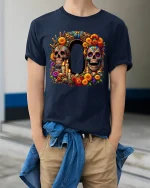 Colorful Sugar Skull Tee with Floral Art and Decorative Style - model wearing navy tee with hands in pockets