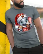 Cute Christmas Elephant Tee with Gingerbread and Hot Cocoa Joy - model wearing grey tee, leaning on column