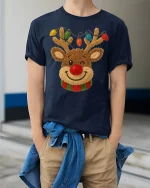 Cute Reindeer Tee with Colorful Christmas Lights and Cozy Charm - model wearing navy tee with hands in pockets