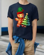 Cute Gingerbread Tee with Christmas Tree and Festive Holiday Charm - model wearing navy tee with hands in pockets