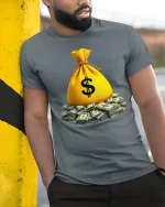 Money Bag Tee with Pile of Cash Graphic Rich Vibes Style - model wearing grey tee, leaning on column
