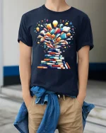 Creative Book Explosion Tee With Bright Ideas And Knowledge - model wearing navy tee with hands in pockets