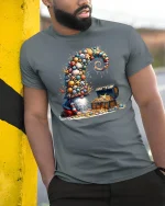 Whimsical Treasure Gnome Graphic Tee With Ocean Shell Fantasy Art - model wearing grey tee, leaning on column