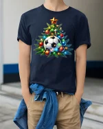 Festive Soccer Ball Christmas Tree Holiday Sports Graphic Tshirt - model wearing navy tee with hands in pockets