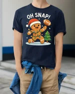 Funny Oh Snap Gingerbread Football Christmas Tshirt Graphic - model wearing navy tee with hands in pockets