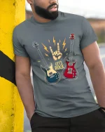 Lets Rock Electric Guitar Hand Sign Music Lover Graphic T Shirt - model wearing grey tee, leaning on column