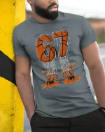 67 Basketball Drip Graphic Tee Bold Court Legend Style Tshirt - model wearing grey tee, leaning on column