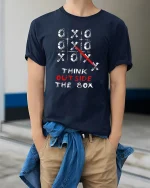 Think Outside The Box Creative Strategy Mindset Graphic Tshirt - model wearing navy tee with hands in pockets