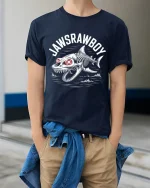 Jawsrawboy Skeleton Shark Horror Ocean Art Graphic Tee Tshirt - model wearing navy tee with hands in pockets