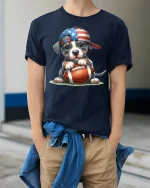 Cute American Puppy Football Graphic Tee Patriotic Sports Art - model wearing navy tee with hands in pockets