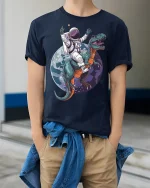 Astronaut Riding Dinosaur Space Adventure Art Tee Funny Sci Fi - model wearing navy tee with hands in pockets