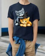 Adorable Three Kittens Cuddle Graphic T Shirt - model wearing navy tee with hands in pockets