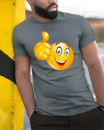 Funny Thumbs Up Smiley Face Cartoon Graphic T Shirt - model wearing grey tee, leaning on column