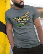 Crocodile Warplane Cartoon Graphic T Shirt Military Humor Art - model wearing grey tee, leaning on column