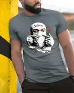 Believe Masked Street Rebel Urban Graphic T Shirt - model wearing grey tee, leaning on column