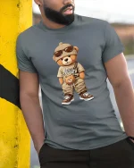 Cool Streetwear Teddy Bear Cartoon Graphic T Shirt Urban Style - model wearing grey tee, leaning on column