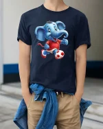 Cute Soccer Elephant Playing Football Cartoon Graphic T Shirt - model wearing navy tee with hands in pockets