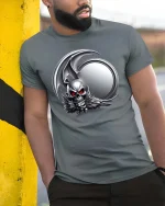 Dark Gothic Skull Winged Demon Emblem Graphic T Shirt - model wearing grey tee, leaning on column