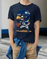 Fierce Eagle Football Player Cartoon Graphic T Shirt - model wearing navy tee with hands in pockets