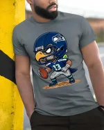 Fierce Eagle Football Player Cartoon Graphic T Shirt - model wearing grey tee, leaning on column